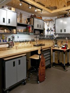 a workbench with lots of tools in it and some shelves on the wall