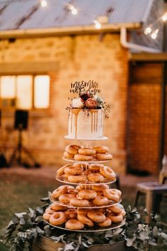 a three tiered cake with frosting and sprinkles