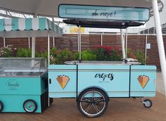 an ice cream cart is sitting under a canopy