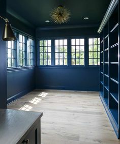 an empty room with blue walls and wooden flooring is seen on the instagram page