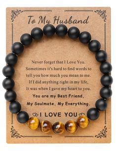 a bracelet with two black beads and an i love you message