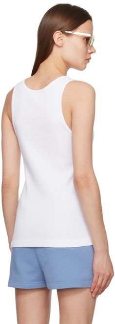 Rib knit cotton tank top. · Scoop neck · Embroidered logo patch at chest Supplier color: White Summer Cotton Tank Top With Ribbed Neckline, Cotton Tank Top With Ribbed Neckline For Summer, White Tank Top With Ribbed Crew Neck, Fitted Cotton Tank Top With Ribbed Neckline, White Crew Neck Tank Top With Ribbed Neckline, White Yoga Camisole Tank Top, White Sleeveless Tank Top With Ribbed Neckline, White Tank Top With Ribbed Neckline, White Fox Tank Top