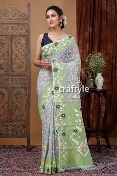 This French Grey and Tea Green Bengal Jamdani Saree is a must-have for any saree lover. Handloomed with the finest quality fabric, it features delicate motifs of geometric, figural, and floral patterns, showcasing the rich heritage of Bengal. Its lightweight design makes it perfect for any occasion, and the soft texture of the fabric ensures comfort. Elevate your style and embrace the timeless beauty of the Bengal tradition with this exquisite piece.Type : Soft Jamdani Saree Saree Length : 5.5 meters Blouse Piece : No Design : Woven Work Fabric : Resham Washing : Dry Clean Get this exclusive jamdani weaved saree online at Craftyle - The best online store for pure silk saree, tussar silk saree and cotton saree. Transitional Green Saree With Resham Embroidery, Transitional Season Green Saree With Resham Embroidery, Green Bohemian Saree With Pallu, Bohemian Style Green Saree With Pallu, Bohemian Green Saree With Pallu Detail, Bohemian Green Saree With Pallu, Green Saree With Motifs For Festivals, Bohemian Green Embroidered Saree, Green Bohemian Embroidered Saree