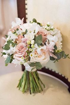 a bouquet of flowers sitting on top of a table next to a mirror with an instagram button