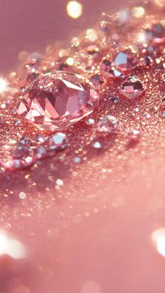 some pink diamonds are laying on top of each other in the light and sparkles