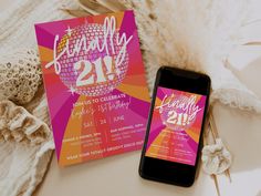 a cell phone sitting on top of a table next to a pink and orange party card