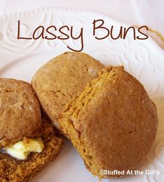 two muffins on a white plate with the words lassy buns above them