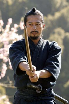 a man holding a baseball bat while wearing a kimono