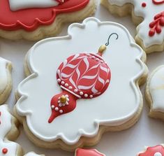 decorated cookies with red and white decorations on them