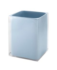 a blue square vase sitting on top of a white table