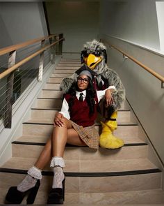 a woman sitting on some stairs with a stuffed bird