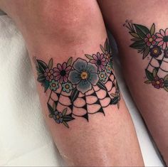 two tattoos on the legs of people with flowers and geometric shapes in them, one is blue and the other is pink