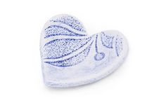 a blue and white heart shaped dish on a white background