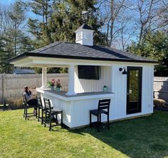 a woman sitting at a bar in the back yard