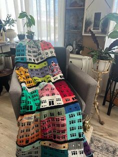 a couch with a multicolored blanket sitting on top of it