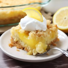 a slice of lemon crumb pie on a plate with a fork and bowl in the background