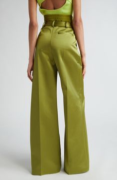 Smooth, satiny pants feature an inner elastic waist plus a classic tailored waistband for a stacked effect on these stunning pants cut with wide flared legs. 34 1/2" inseam; 29" leg opening; 13" front rise; 14 1/2" back rise (size 4) Elastic waist with snap closure; zip fly with hook-and-bar closure Front slant pockets; back welt pocket 91% polyester, 5% elastane, 4% polyurethane Dry clean Made in the USA Designer Clothing High-waisted Silk Wide Leg Pants For Evening, Silk High-waisted Wide Leg Pants For Evening, Silk High-waisted Wide Leg Evening Pants, Satin Wide Leg Pants For Workwear, Chic Silk Bottoms With Bias Cut, Full Length Wide Leg Satin Pants For Work, Chic Silk Bias Cut Bottoms, Elegant Wide Leg Satin Pants For Formal Occasions, Chic Satin Bottoms For Formal Occasions