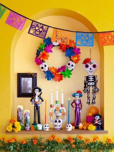 the day of the dead decorations are on display in front of an arch with candles