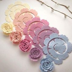 paper flowers are arranged on a white surface