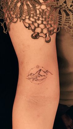 a woman's arm with a tattoo design on the left side of her body