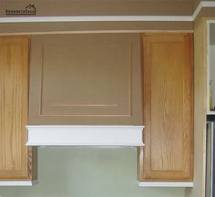 an empty kitchen with wooden cabinets and white counter tops on the wall above the stove