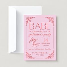 a pink and red baby shower card with the word babe on it, next to an envelope