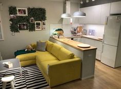 a yellow couch sitting in the middle of a kitchen