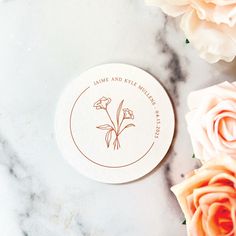 some flowers and a white plate on a marble surface