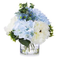 a glass vase filled with blue and white flowers