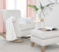 a white chair and ottoman in a room