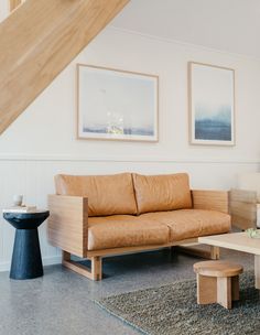 a living room filled with furniture and pictures on the wall above it's coffee table