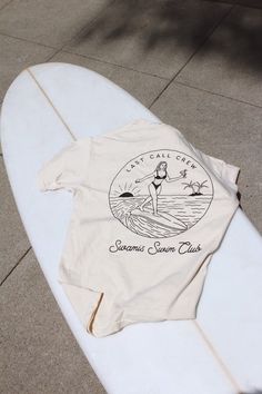 Surfer tee with a vintage vibe. Board under your feet, martini in hand, sunset on the beach, what more do you need. Available in Cream and Heather Gray. heavyweight t-shirt with a soft, worn-in feel. 100% ringspun cotton screen printed in California unisex sizing Female wearing size medium: 5’7” 130 lbs Male wearing size XL: 6’4” 195 lbs Pool Shirts, Sunset On The Beach, Towel Dress, Surf Design, Surf Tee, Beach Tee, Surf Shirt, California Surf, Surf Tshirt