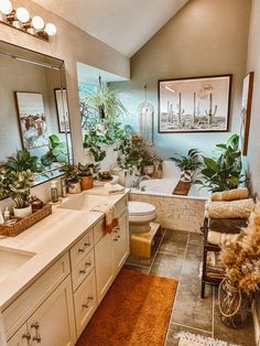 a bathroom with a tub, sink, toilet and mirror is shown in this image