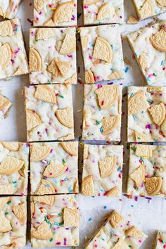 some cookies and sprinkles are arranged on a table