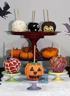 an assortment of halloween treats on a cake stand