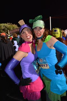 two women dressed in costumes posing for the camera