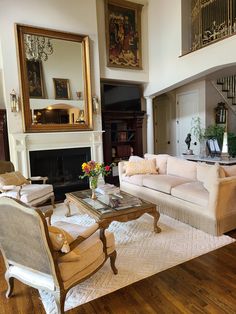 a living room filled with furniture and a fire place in the middle of a room