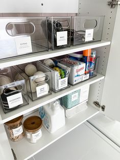 an organized pantry with clear bins and labels on the shelves, including toiletries