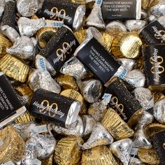 many chocolates are wrapped in foil and sitting on top of each other