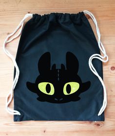 a black bag with yellow eyes on it