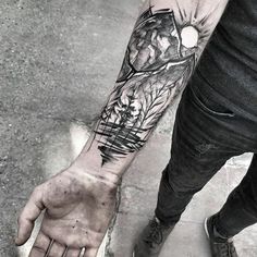 a man with a tattoo on his arm holding onto the hand of another person who is wearing jeans