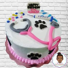 a decorated birthday cake with a stethoscope and dog's paw prints