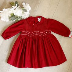 This Little Red Smocked Dress Is Super Sweet!! The Soft Pin Wale Corduroy, Made Of 100% Cotton Is Sure To Keep Your Sweet Girl Cozy During Cool Months. This Dress Is Perfect For Transitioning Between Seasons. The Bodice Is Fully Smocked With A Lattice Design Embroidery. Beneath The Lattice Design Is A Smocked Panel That Is Bordered By A Red And White Rope-Stitched Embroidery. In The Center Of The Smocked Panel Are Embroidered White Bullion Roses With Red Centers And White Buds, Along With Blue A White Hair Bows, Dress Traditional, White Tights, White Rope, Lattice Design, Design Embroidery, Kids Boutique, Smocked Dress, Pan Collar