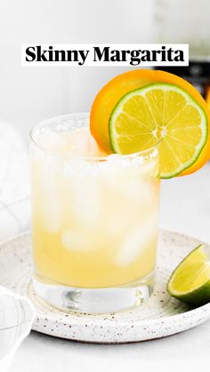 two glasses filled with drinks and garnished with an apple on the rim, sitting next to each other