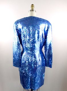 "This is an EXQUISITE hand sewn sequin dress and jacket! This ensemble is fully embellished with iridescent bright blue sequins. It's in perfect condition! Jacket Bust - 38/40\" Jacket Waist - 30\" Jacket Length - 29\" Skirt Waist - 28\" Skirt Hips - 40\" Skirt Length - 20\" This dress comes from a pet-free and smoke-free home. If you would like more info or have any questions, please don't hesitate to ask!" Blue Sequin Dress For Wedding, Blue Fitted Long Sleeve Sequin Dress, Blue Fitted Sequin Fabric For Night Out, Fitted Blue Sequin Fabric For Night Out, Fitted Iridescent Evening Dress, Iridescent Fitted Evening Dress, Fitted Iridescent Dress For Evening, Elegant Blue Sequin Fabric For Formal Occasions, Blue Long Sleeve Sequin Dress For Formal Events