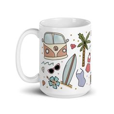 a white coffee mug with various items on the front and side, including a surfboard