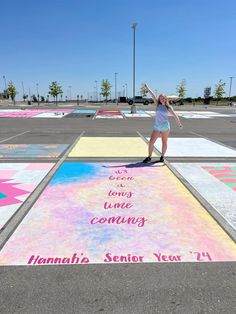 a woman standing on top of a painted parking lot