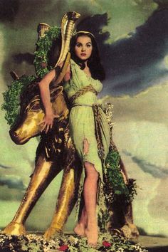 a painting of a woman holding a large golden object in front of a man on a horse