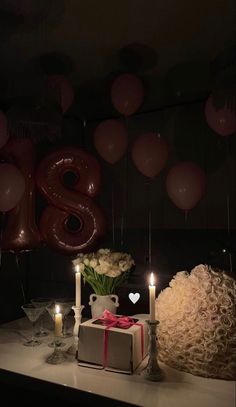 the table is set with candles and balloons