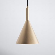 a light that is hanging from the ceiling with a white wall in the back ground